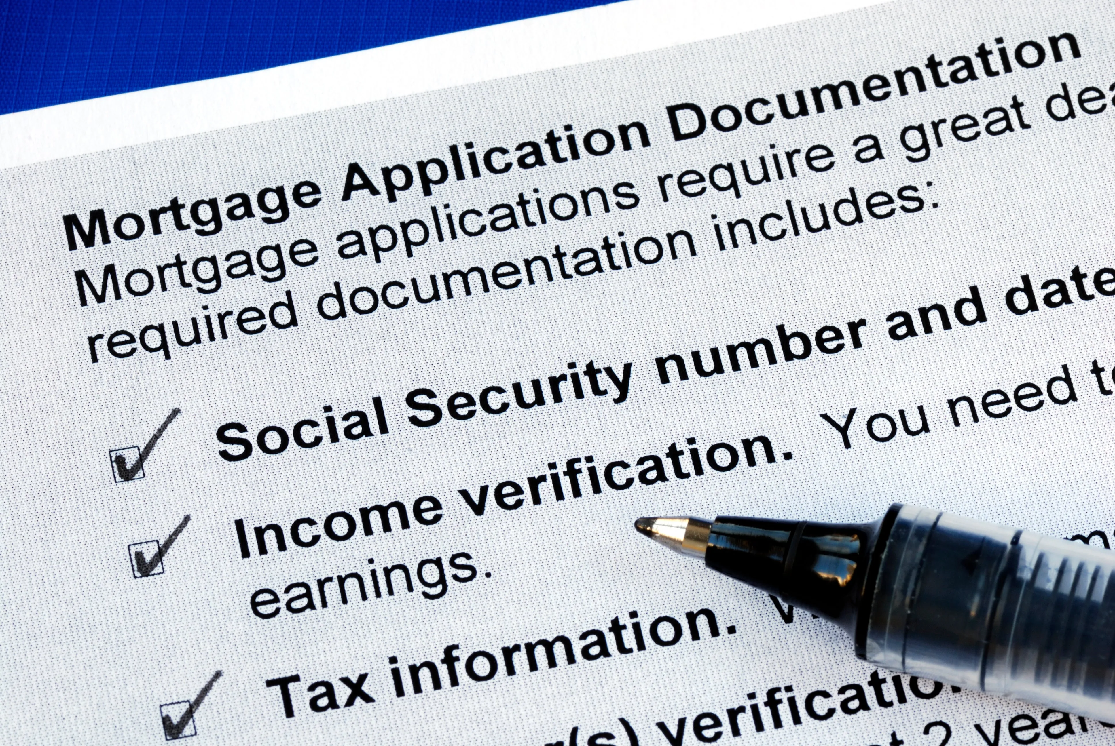 Closeup of a stack of documents that says mortgage application documents.