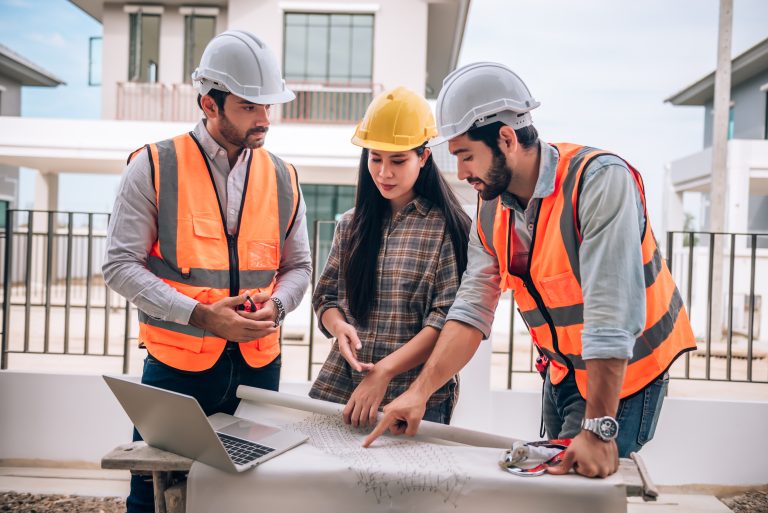 civil-engineer-construction-worker-architects-wearing-hardhats-safety-vests-are-working-together-construction-site-building-home-cooperation-teamwork-concept