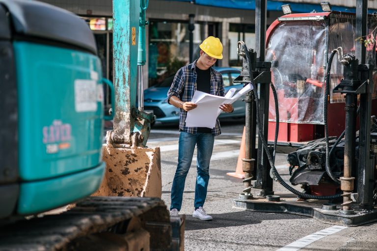 Civil engineers work on large road and machinery conditions