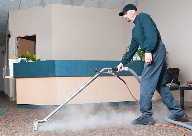 Man steam cleaning the carpet of an office building