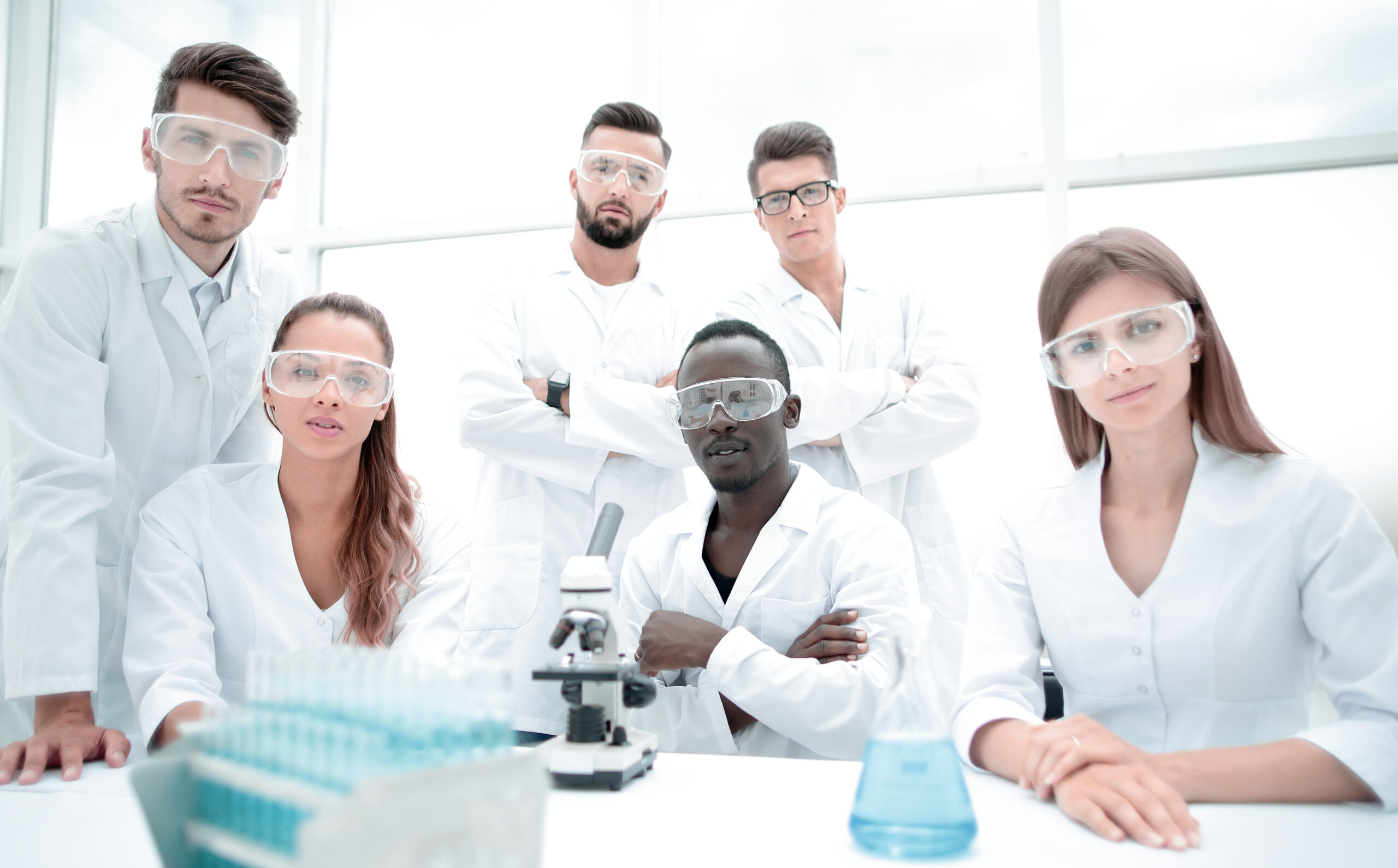 group-young-successful-scientists-posing-camera-scaled