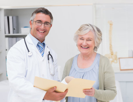 doctor showing some documents to the elderly woman