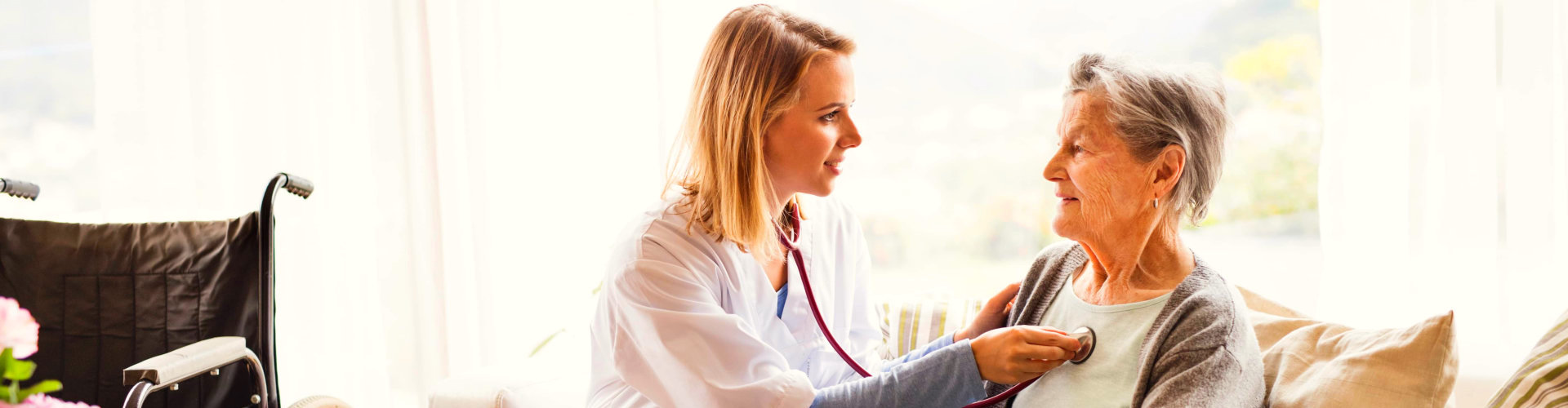 woman checking the health of senior woman