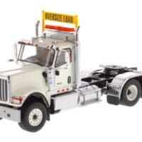 A white truck with a sign on the back of it.
