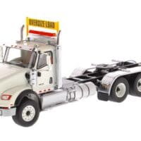 A white truck with a yellow sign on the side.