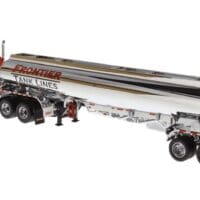 A large tanker trailer is parked on the side of the road.