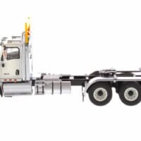 A white semi truck with its cab up.