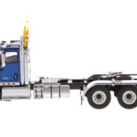 A blue semi truck with the cab up.