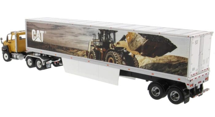 A tractor trailer with a picture of a construction scene on the side.