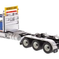 A semi truck with the cab up and its trailer down.