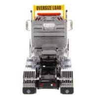 A large truck with a yellow sign on it's side.