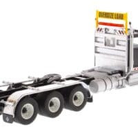 A semi truck with the cab up and its trailer down.