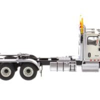 A white truck is parked on the side of the road.