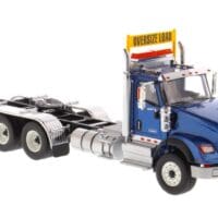 A blue truck with a yellow sign on the back.