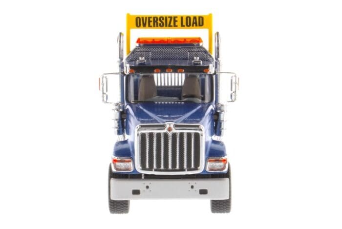 A large truck with an oversize load sign on the front.