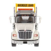 A large truck with an oversize load sign on the front.