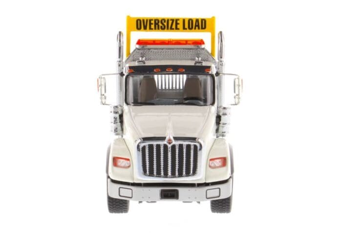 A large truck with an oversize load sign on the front.