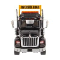 A large truck with an oversize load sign on the front.