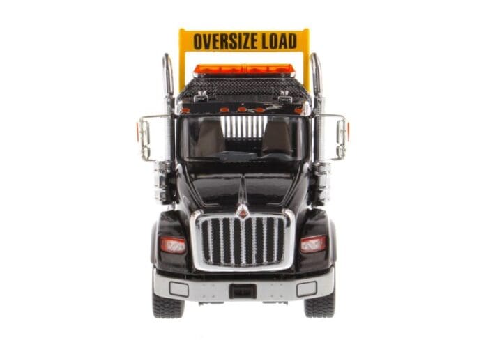 A large truck with an oversize load sign on the front.