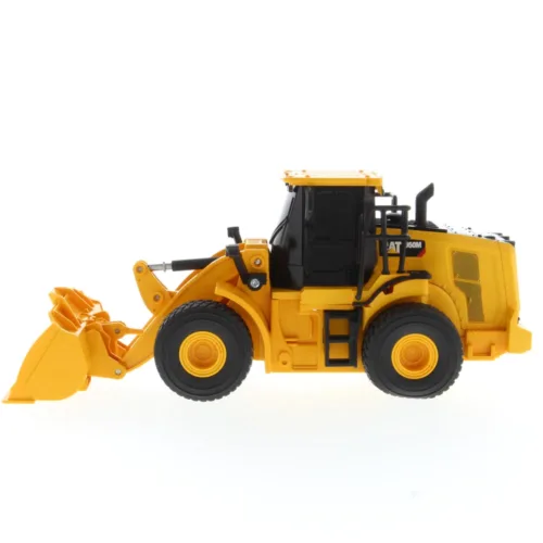 A yellow and black toy tractor is on the floor