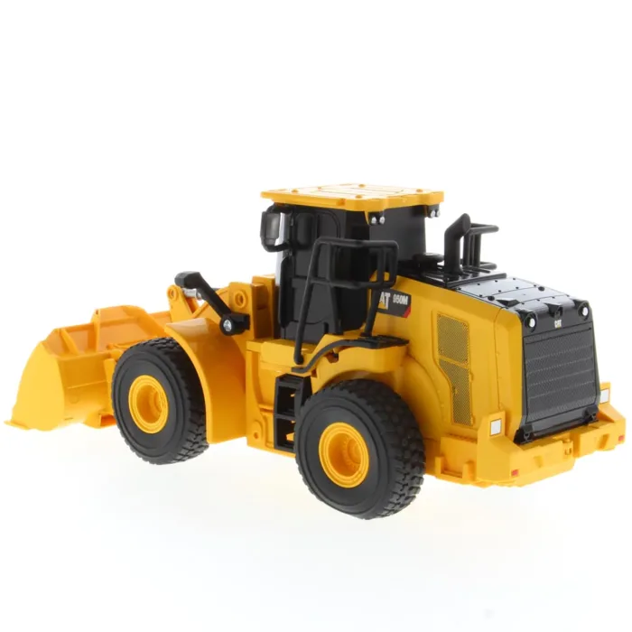 A yellow and black toy tractor is on the floor