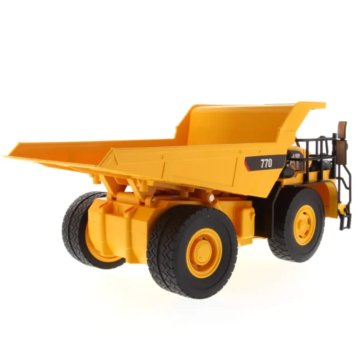 A yellow dump truck is parked on the ground.