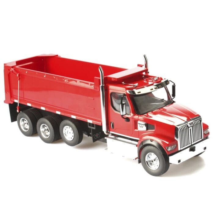 A red dump truck is parked on the side of the road.