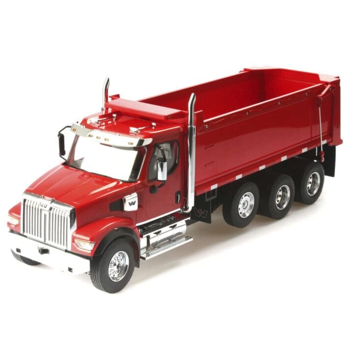 A red dump truck is parked on the side of the road.