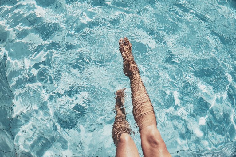 Beautiful womans legs in the pool